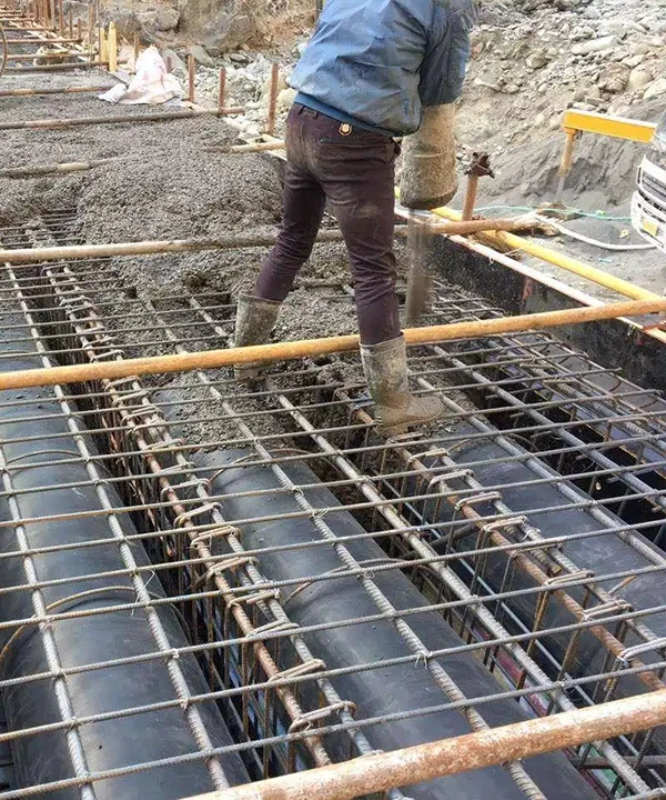 Construction workers sealing pipes